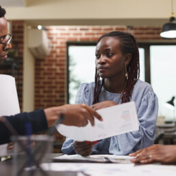 Marketing company team leader briefing coworkers about startup project presentation