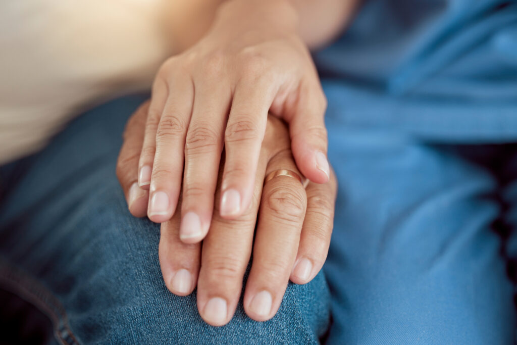 Support, empathy and trust with holding hands of old woman and nurse in retirement home for hope, c